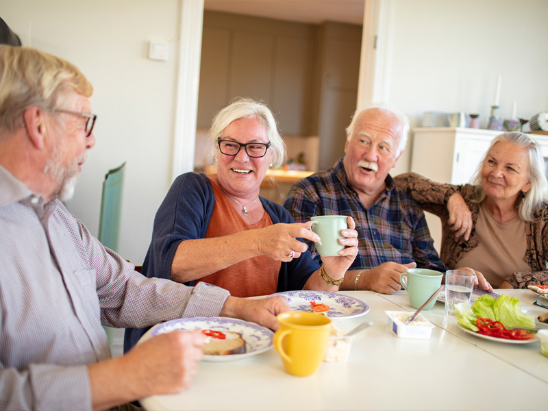 a group of people sitting at a table eating food